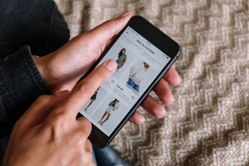 a person holding a smartphone clicks on an online shopping site