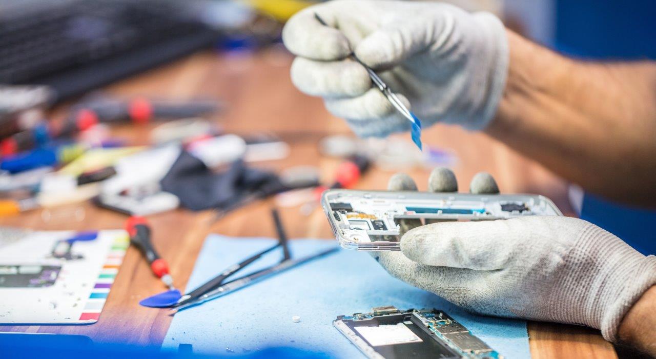 A person is repairing a smartphone